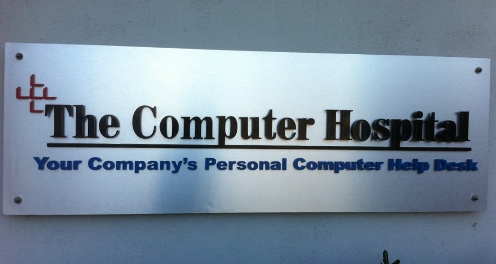 The Computer Hospital wall sign above the reception desk